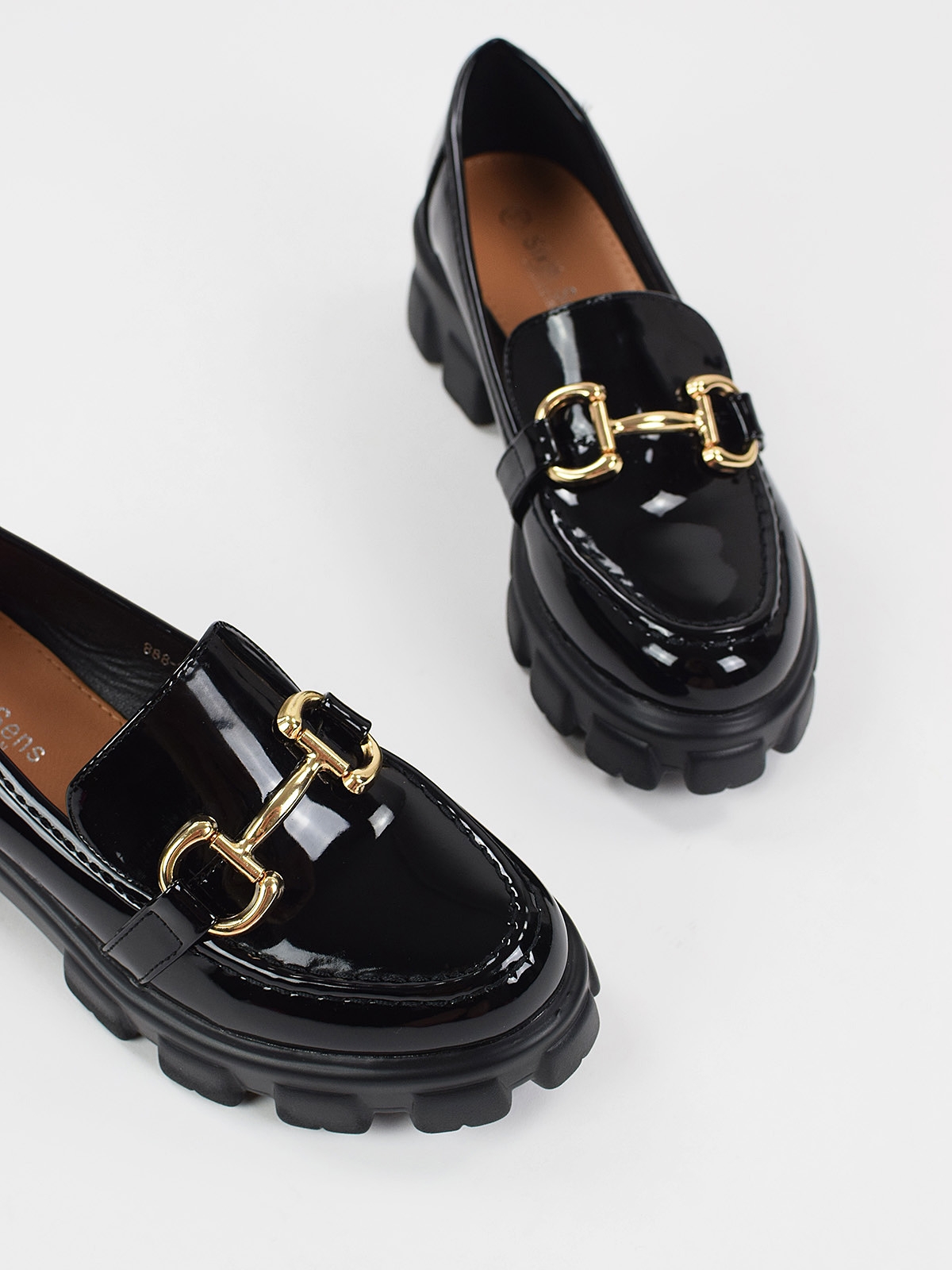 Chunky loafers with gold trim in black patent