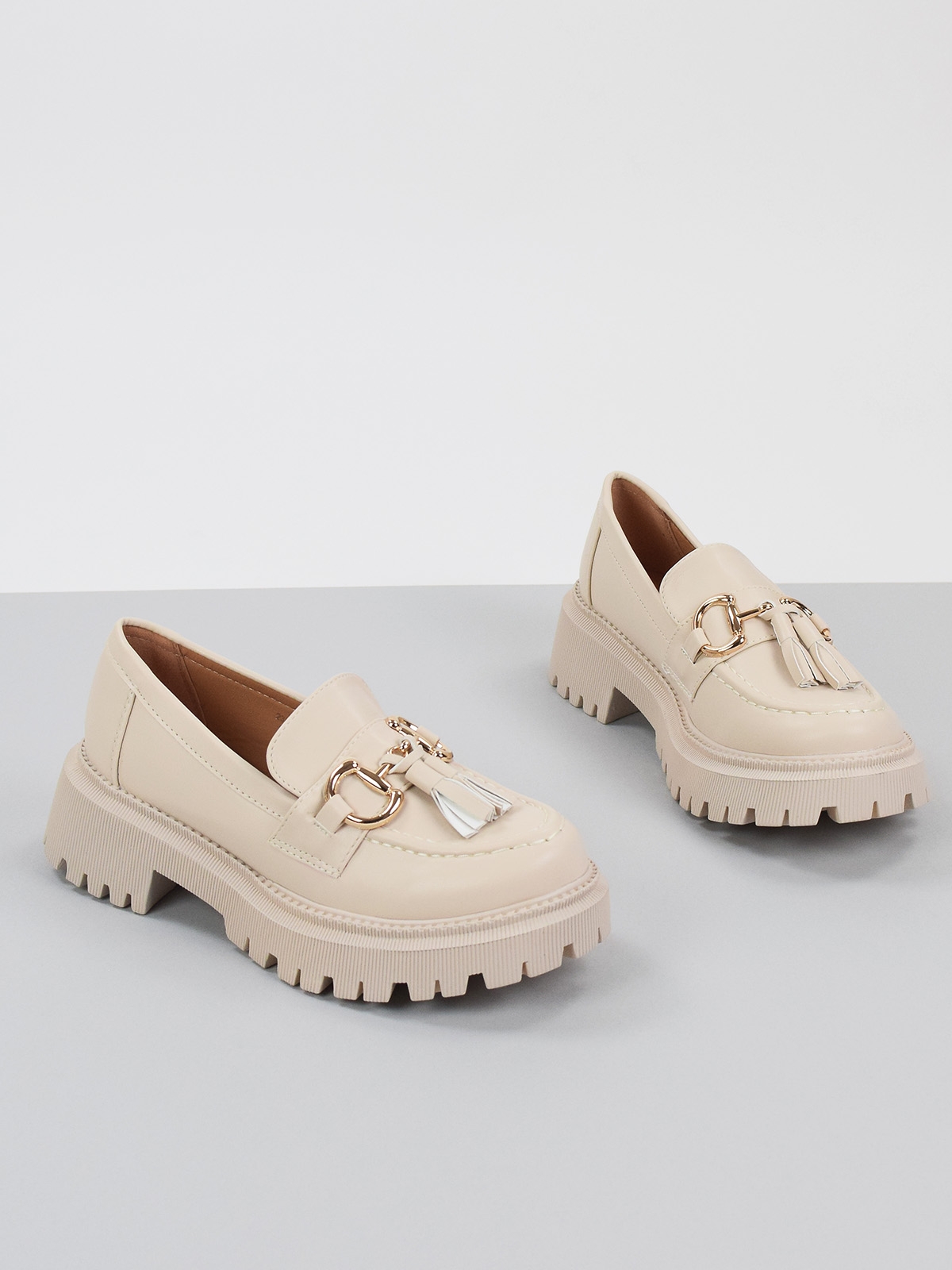 Chunky loafers with front gold trim and tassel in neutral color