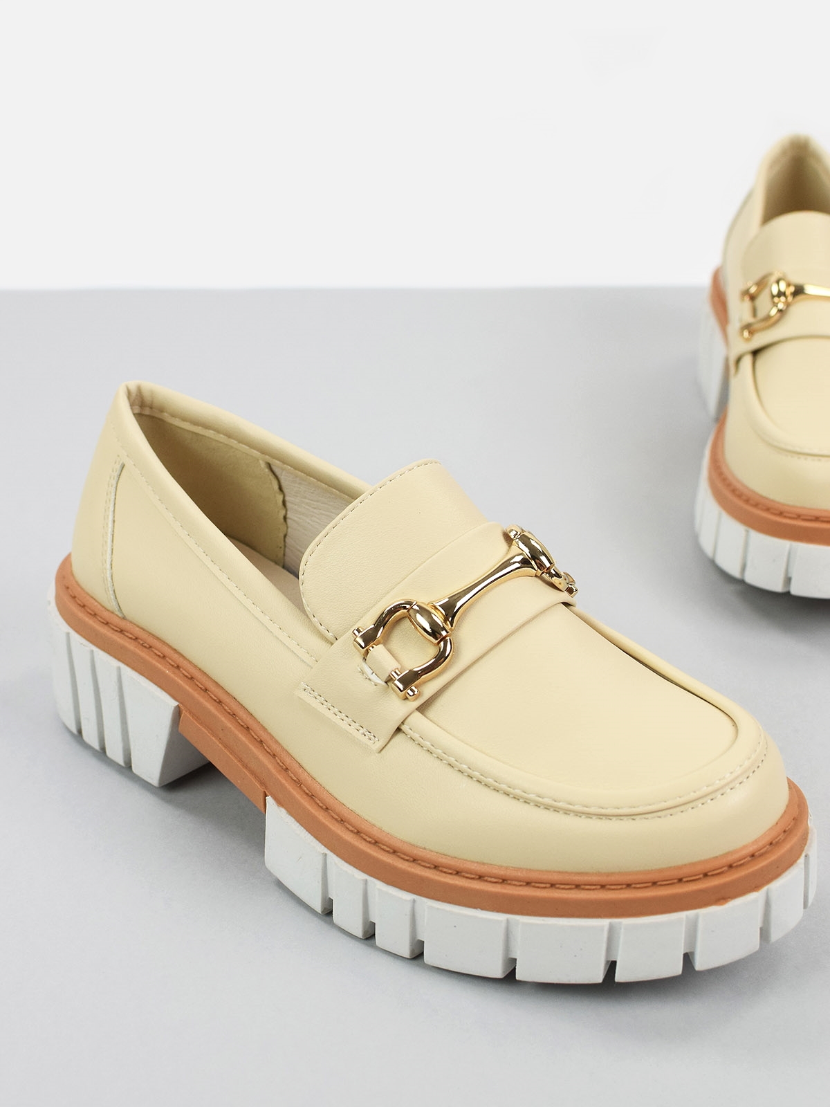 Chunky loafers with front gold trim in neutral color