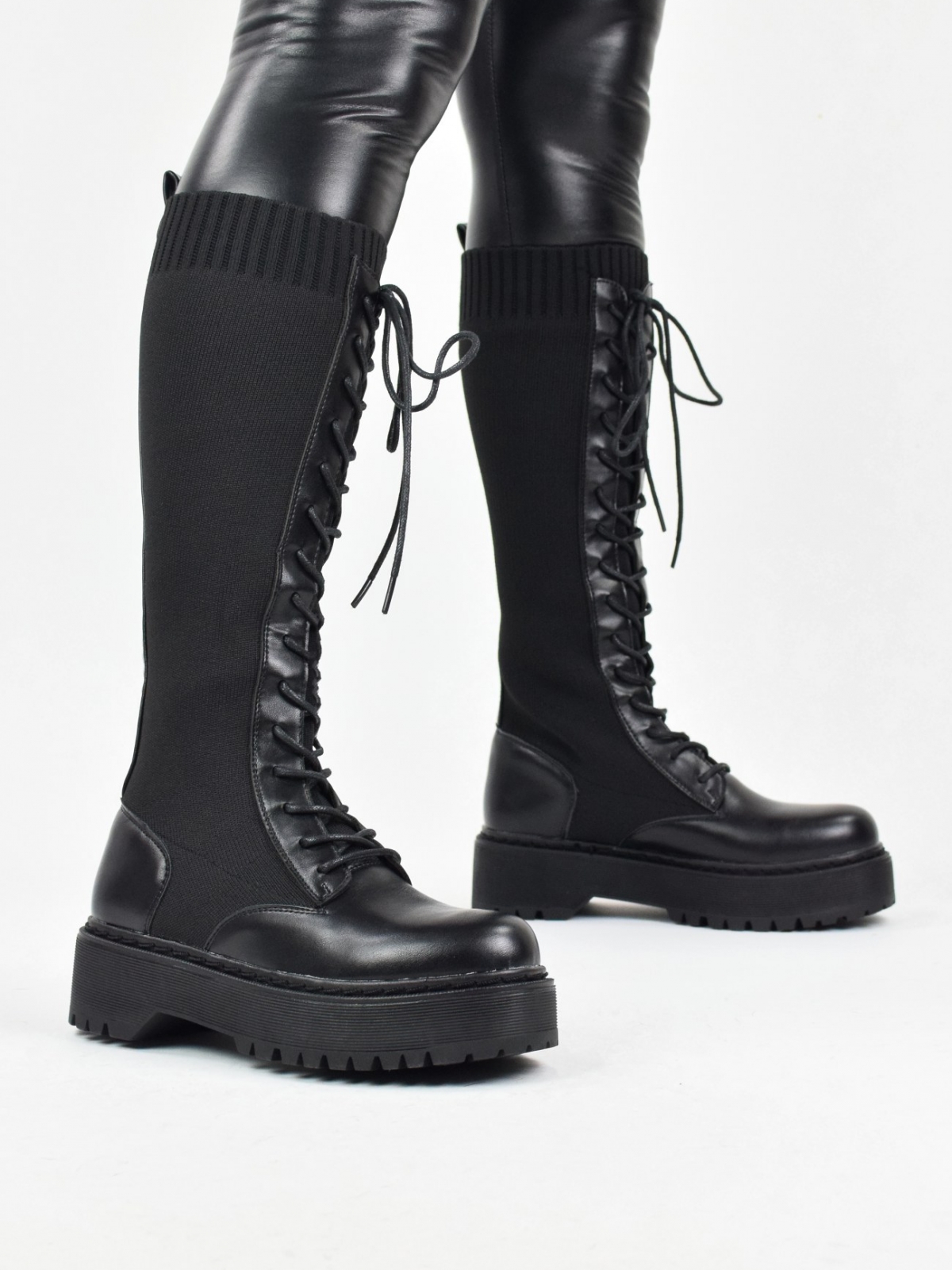 Chunky lace up knee high knitted boots in black