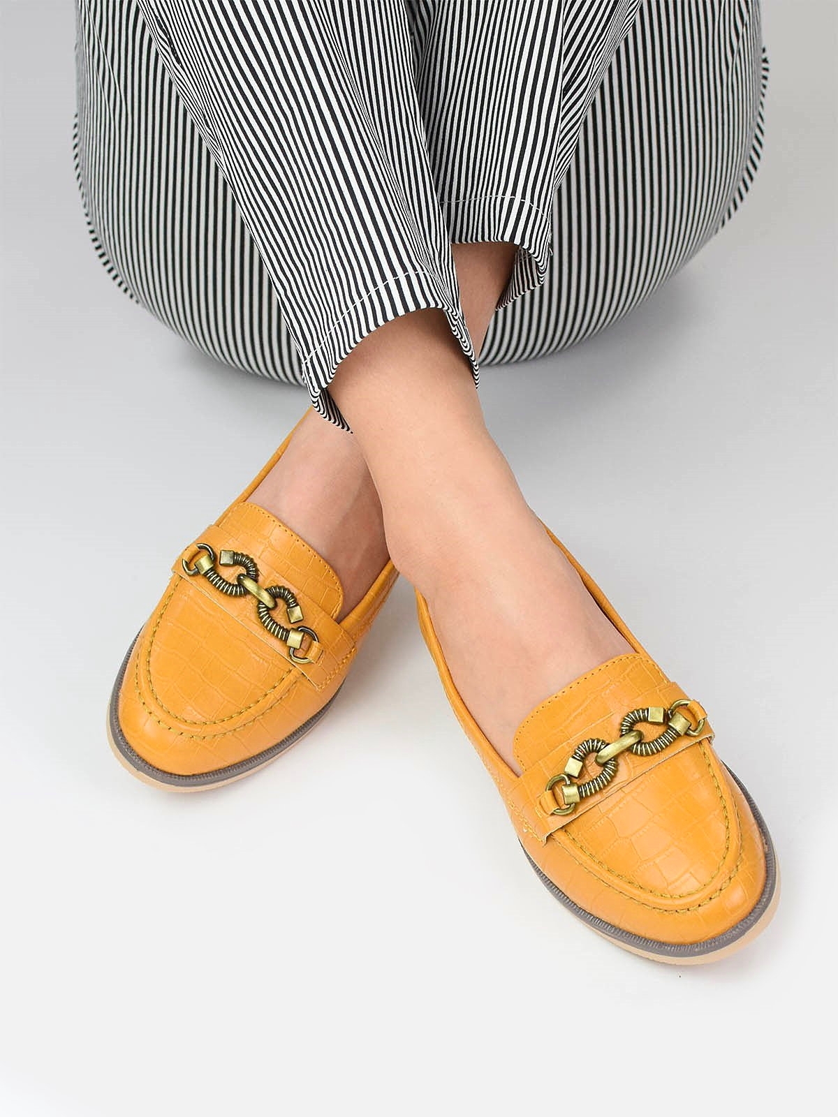 Loafers with gold tone detail in yellow