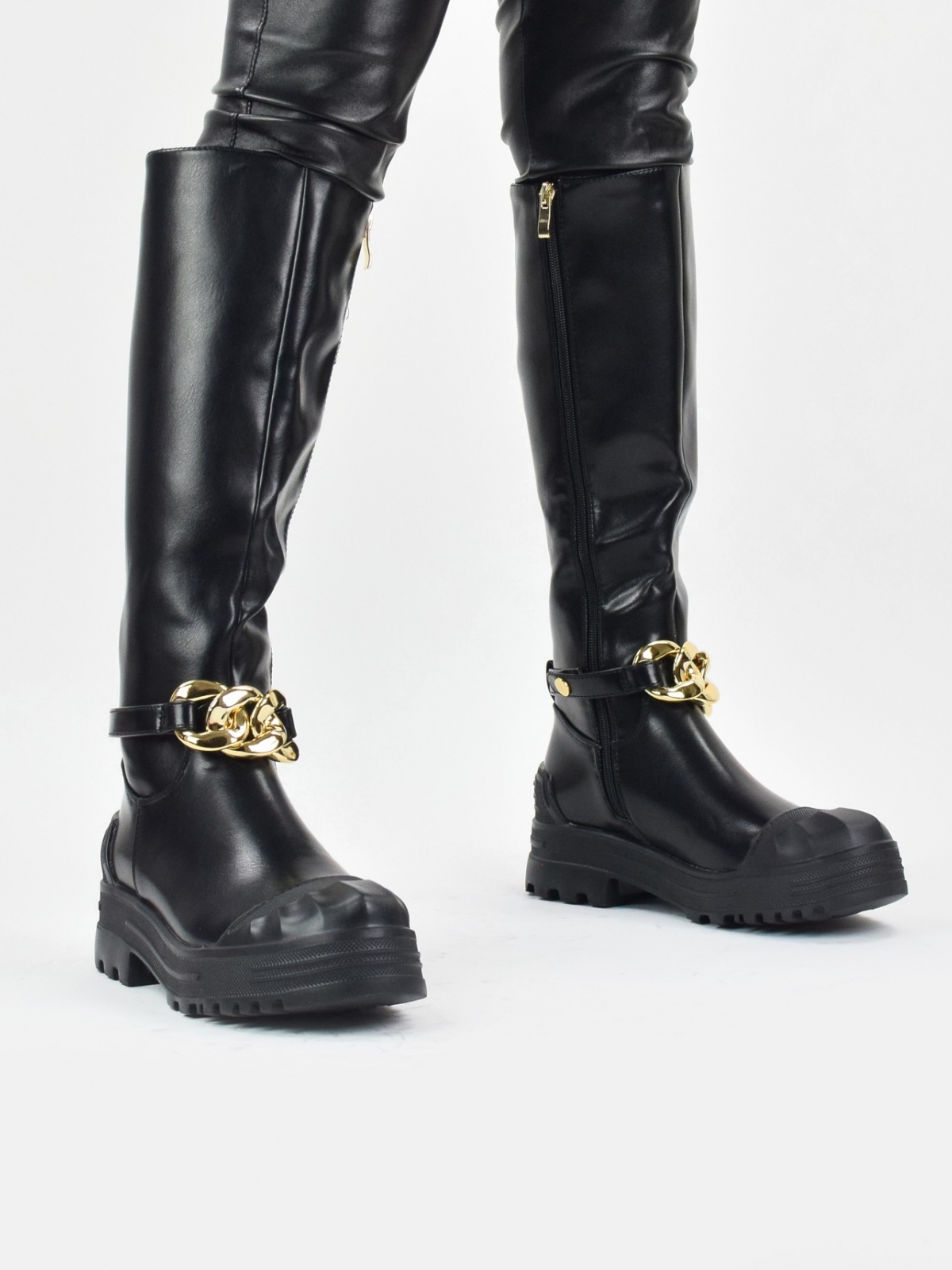 Chunky knee high boots with front chain in black