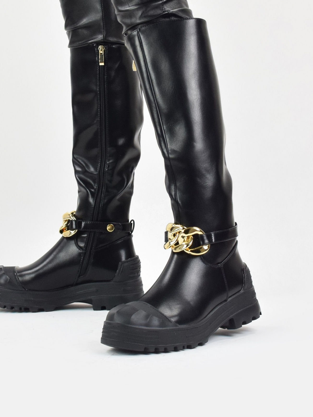 Chunky knee high boots with front chain in black